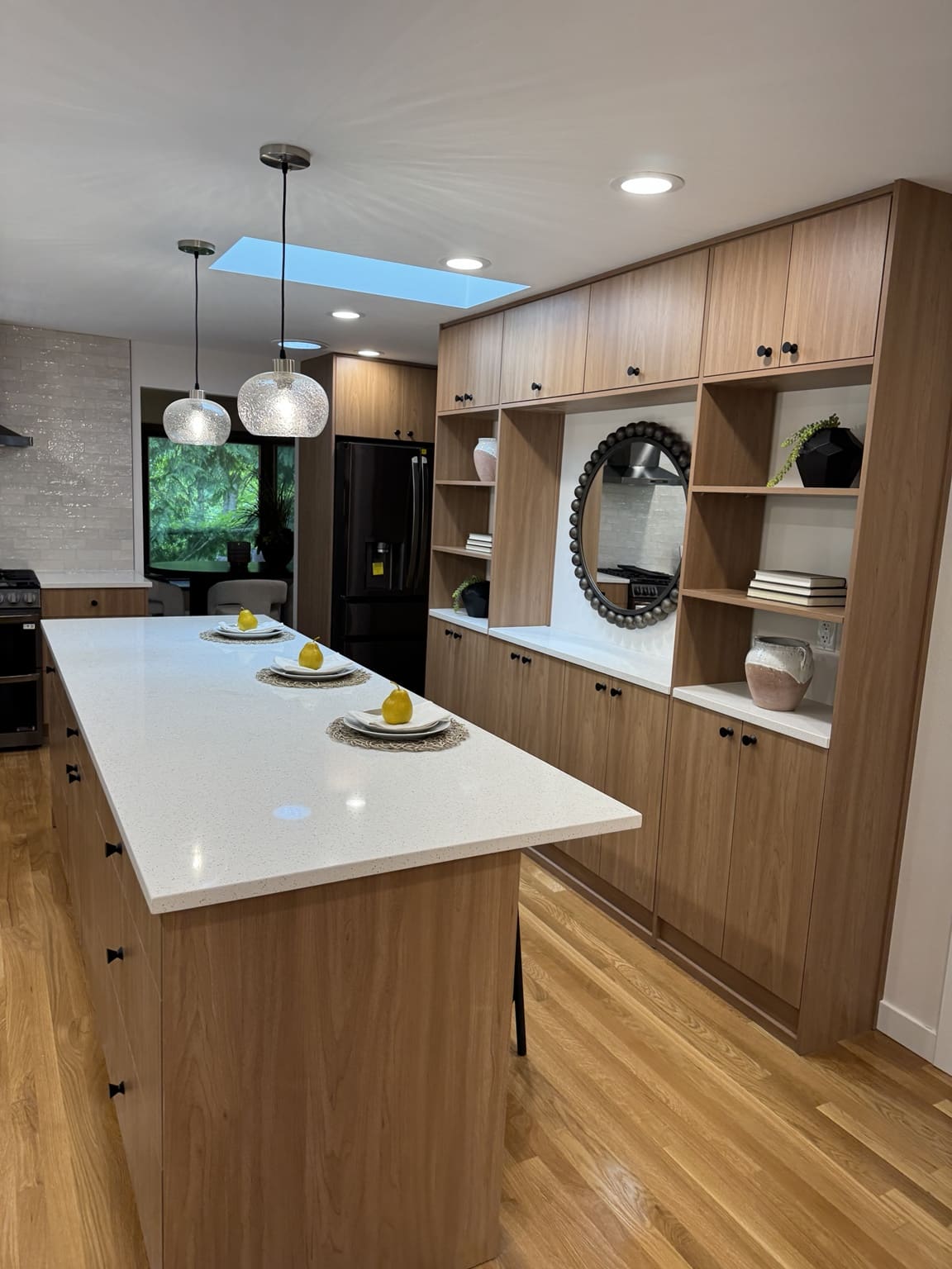 Large quartz island and custom wood display cabinets in Mercer Island remodel