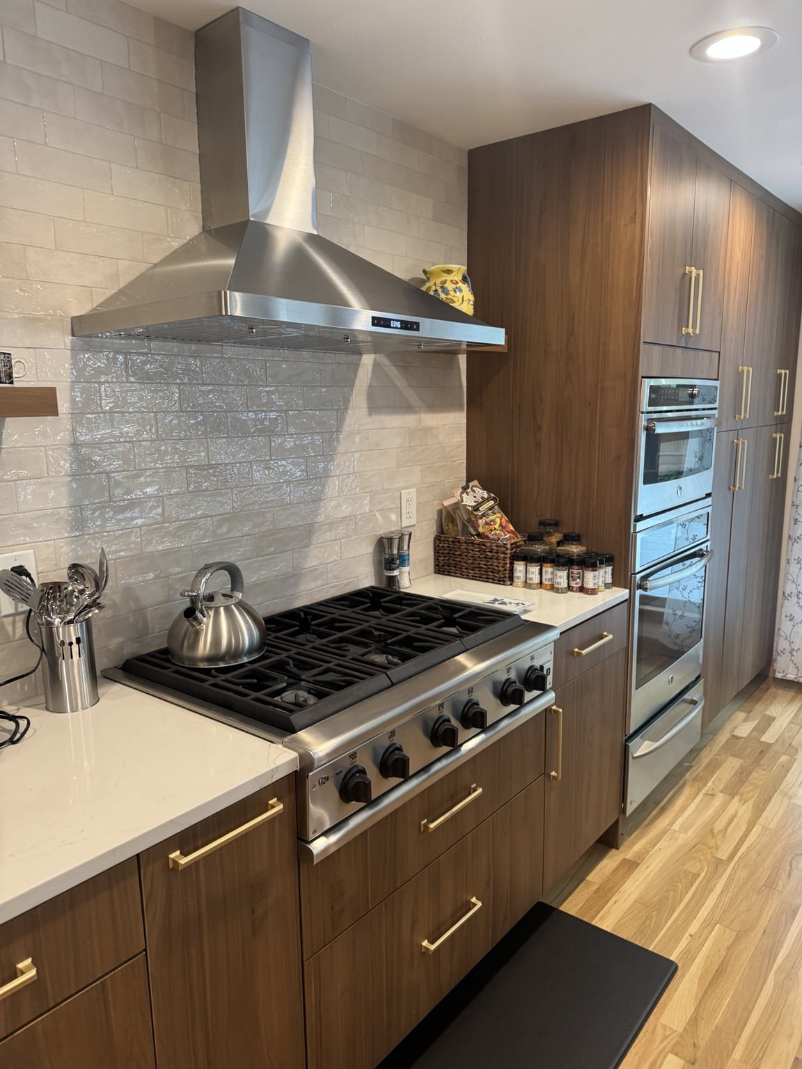 Professional range, hood, tile backsplash and flat-panel cabinets in Kirkland kitchen