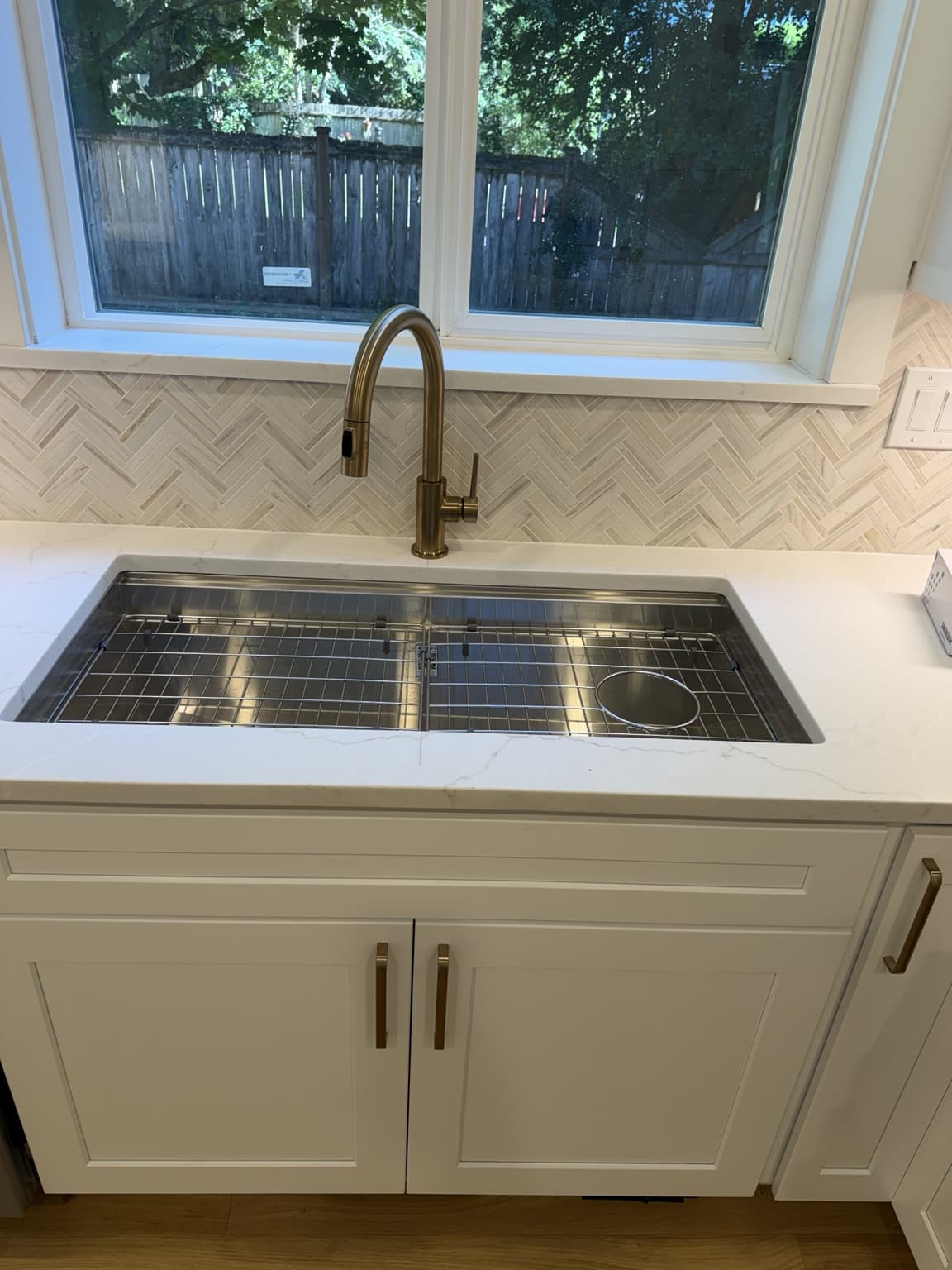 New workstation sink, faucet, quartz countertop and tile backsplash