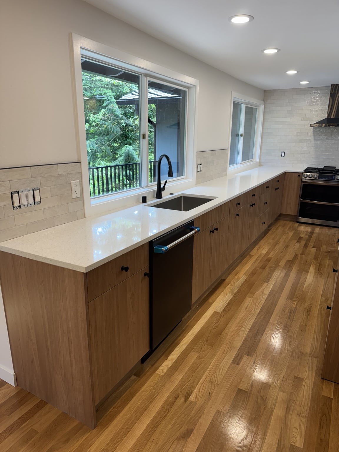 New sink, quartz countertops, cabinets, backsplash and flooring in Mercer Island kitchen